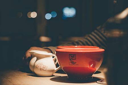 red ceramic bowl on brown wooden surface thumbnail