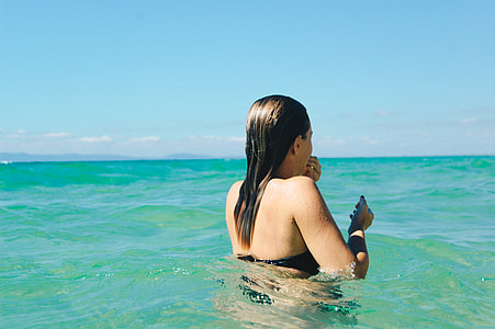 woman swimming in ocean at daytime thumbnail