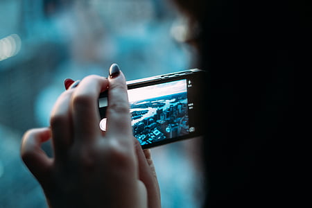 selective focus photography of person taking picture thumbnail