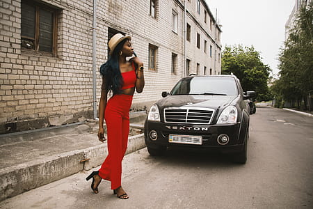 Woman Walking in Front of Black Suv thumbnail