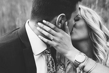grayscale photography of man and woman kissing thumbnail