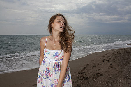 woman walking on seashore during sunset thumbnail