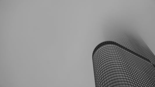 low angle photo building covered with clouds thumbnail