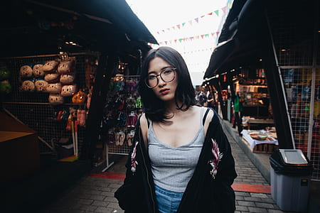 woman standing between store at daytime thumbnail