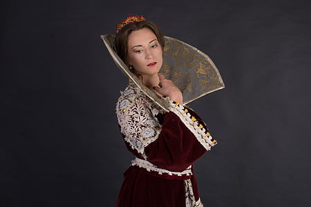 woman wearing maroon and white medieval dress against black background thumbnail