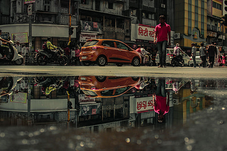 people walking near cars and motorcycles thumbnail