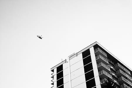 helicopter flew in the air near building thumbnail