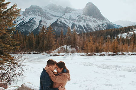 man and woman about to kiss in front of mountain thumbnail