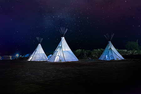 three white tents during night time thumbnail