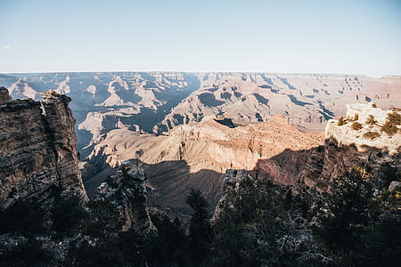 A panoramic view of the sun and shadows sprawling over grand canyons thumbnail