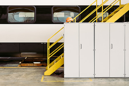 white wooden cabinet beside yellow steel stairs thumbnail