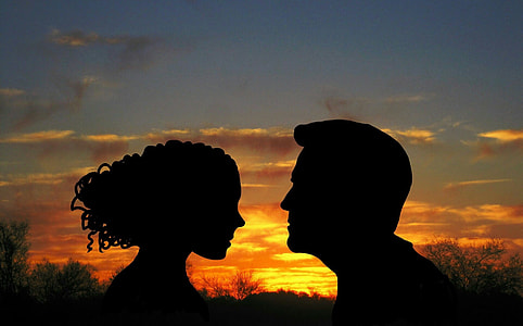 silhouette photo of man and woman in golden hour effect thumbnail