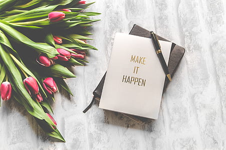 flower bouquet beside notebook and black pen thumbnail