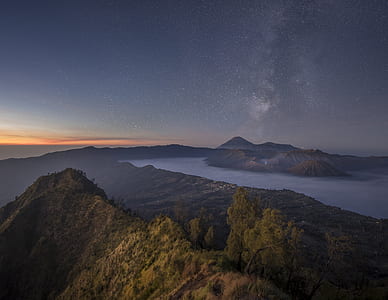 mountain and body of water under gray sky during golden hour thumbnail