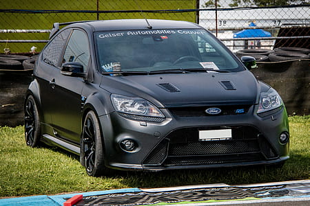 matte black Ford Focus RS 3-door hatchback on green grass during daytime thumbnail
