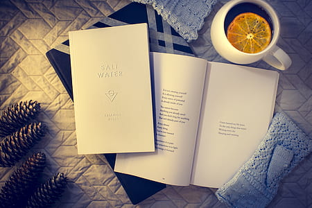 ceramic mug near two books on white surface thumbnail