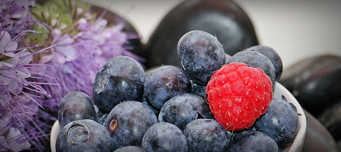 close-up photo of raspberry and blueberry in white ceramic bowl thumbnail