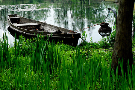 brown rowboat on body of water photo thumbnail