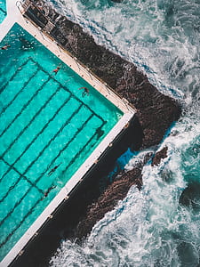 aerial photography of pool near body of water thumbnail