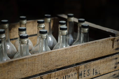 clear glass bottles on brown wooden crate thumbnail