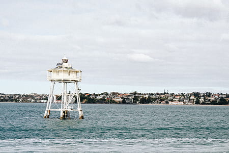 white watchtower on body of water thumbnail