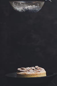 person pouring powder on baked cake thumbnail