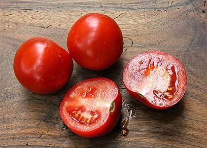 two red tomatoes and one sliced tomato thumbnail