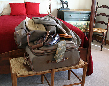 pair of brown leather loafers on luggage bag thumbnail