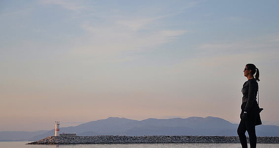 woman facing in front of lighthouse thumbnail