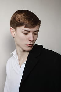 man in black coat looking on his left thumbnail