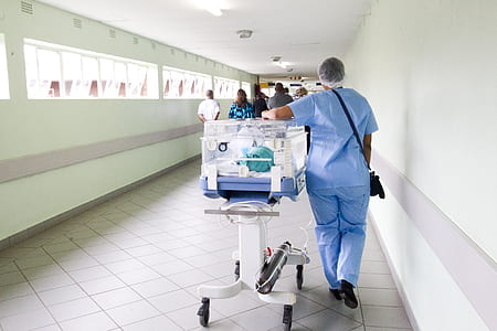 hospital personnel walking with cart thumbnail