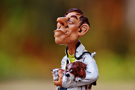 man holding rabbit and dog themed figurine selective focus photography thumbnail