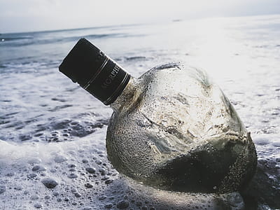 Clear Glass Bottle on Body of Water thumbnail