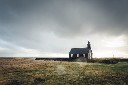 black wooden church on green grass field thumbnail
