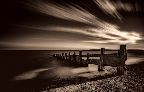 grayscale photo of bridge near body of water thumbnail