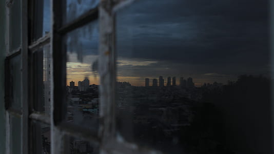 close-up photography of glass window reflecting city building thumbnail