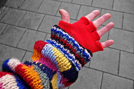 person wearing multicolored fingerless hand warmer thumbnail