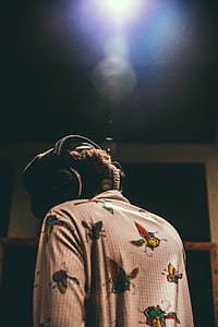 man standing near black wall thumbnail