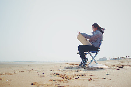 woman sitting on silver chair while painting thumbnail