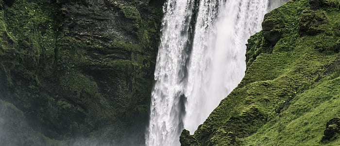 waterfalls beside green mountain thumbnail