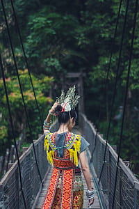 woman walking through suspension bridge thumbnail