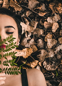 green leaf on woman's face thumbnail