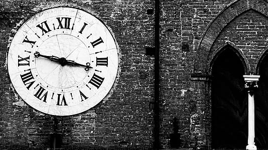 grayscale photography of brick wall with large analog wall clock thumbnail