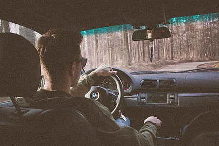 man wearing black sunglasses driving BMW vehicle at daytime thumbnail
