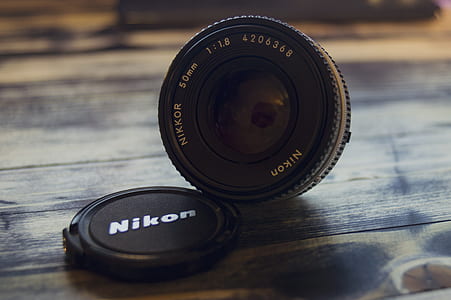 black Nikon camera lens thumbnail