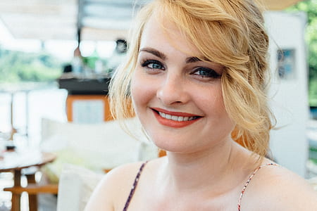 woman smiling near table thumbnail