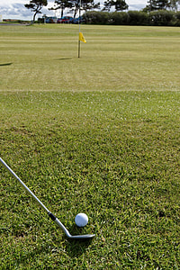 white golf ball near flag thumbnail