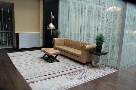 brown leather chesterfield sofa in front of coffee table thumbnail