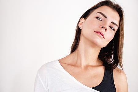 woman in white tops standing near wall thumbnail