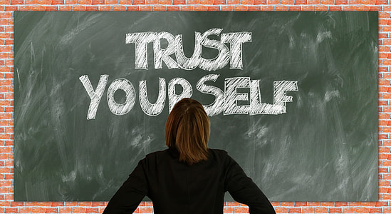 woman wearing black shirt standing in front of chalk board thumbnail